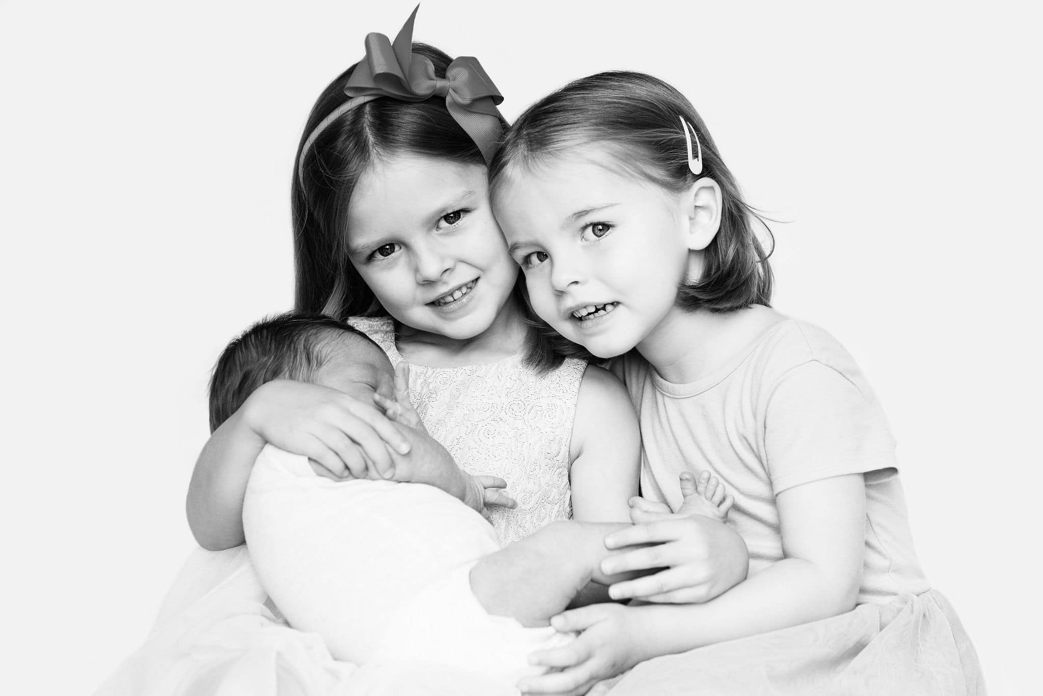 Newborn baby with two siblings during a lifestyle newborn session in Toronto.